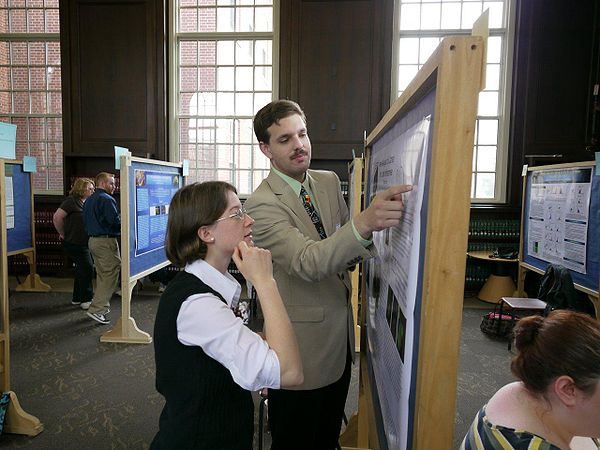 Matt Heiss explains his poster to a fellow student during the Frontiers in Undergraduate Education exhibition at the University of Connecticut, April 16, 2010.